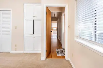 a hallway with white walls and a window at Murphys Wine Country Getaway in Murphys