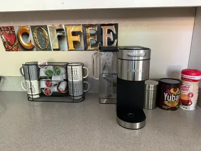 a coffeemaker sitting on a kitchen counter with cups at Murphys Wine Country Getaway in Murphys