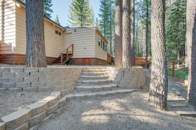 a house in the woods with stairs leading up to it at Hike, Boat and Ski South Lake Tahoe Home in South Lake Tahoe