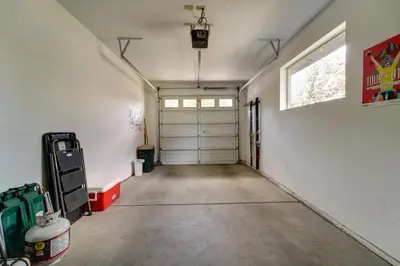 an empty garage with two garage doors and a window at Boulders Truckee Condo Near Donner Lake and Skiing! in Truckee