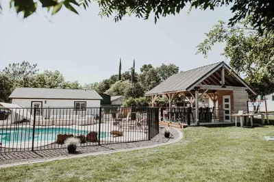 a house with a pool and a fence at Beautiful spacious guest home in Roseville