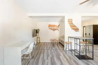 a kitchen and living room with a table and chairs at Beautiful spacious guest home in Roseville