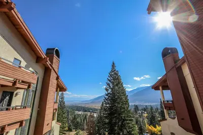 a view of the mountains from between two buildings at Bridges #108 condo in Mammoth Lakes