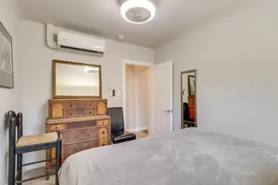 a bedroom with a bed and a mirror and a television at MidTown Reno Vacation Rental with Fenced-In Yard! in Reno