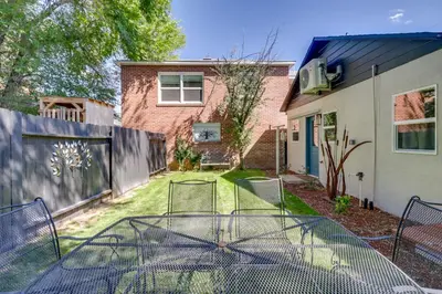 a table in the yard of a house at MidTown Reno Vacation Rental with Fenced-In Yard! in Reno