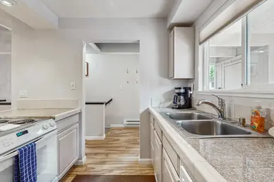 a white kitchen with a sink and a stove at Mountain Shadows in Incline Village