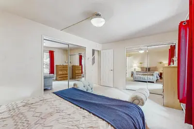 a bedroom with a large bed and mirrors at Mountain Shadows in Incline Village
