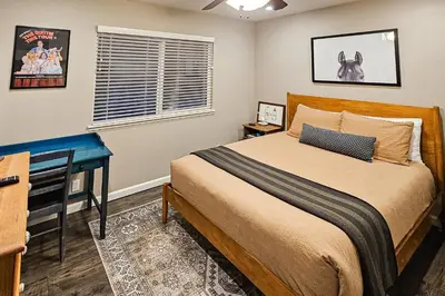 a bedroom with a bed and a desk in it at Jordan Oak in Groveland