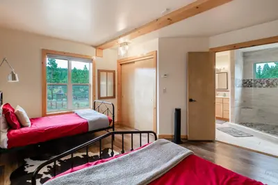 a bedroom with two bunk beds and a bathroom at The Modern Moose Lodge in Truckee