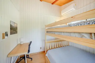 a bedroom with two bunk beds and a desk at Scenic Kernville Getaway with Deck and Mountain Views! in Kernville