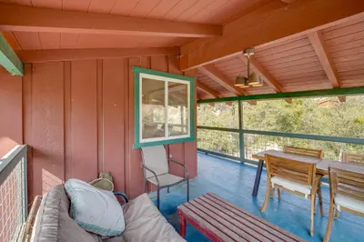 a screened in porch with a couch and a table at Scenic Kernville Getaway with Deck and Mountain Views! in Kernville
