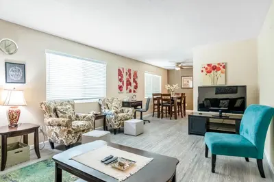 a living room filled with furniture and a tv at Longer Stays for Travelers- Apt Blocks from Hospital, Downtown in Visalia