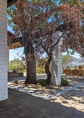 a tree and tables and chairs on a patio at Scenic Spanish Rancho - Breathtaking Views in Three Rivers