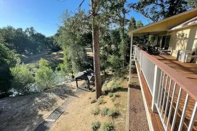 a porch of a house with a bench on it at Creekside Suite Sleeps 2 Creek frontage Bbq in Oakhurst