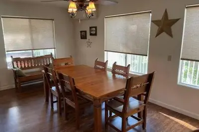 a dining room with a wooden table and chairs at Creekside Suite Sleeps 2 Creek frontage Bbq in Oakhurst