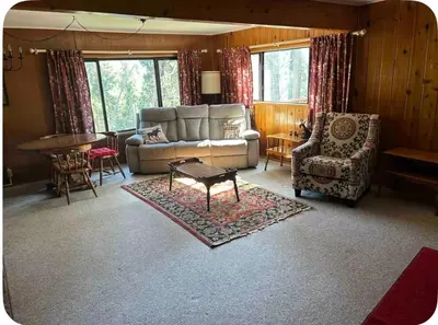 a living room with a couch and a table and chairs at Sequoia National Forest CabinD in Panorama Heights
