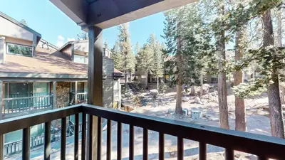a balcony with a view of the woods at Chamonix #64 condo in Mammoth Lakes