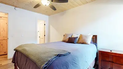 a bedroom with a bed with a wooden ceiling at Chamonix #64 condo in Mammoth Lakes