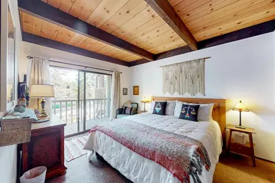 a bedroom with a large bed and a large window at Serene Escape in Kings Beach