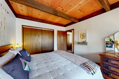 a bedroom with a large bed with a wooden headboard at Serene Escape in Kings Beach