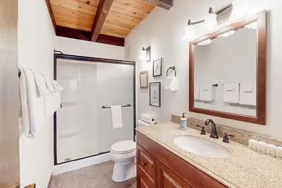 a bathroom with a toilet and a sink and a mirror at Serene Escape in Kings Beach