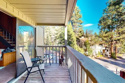 a porch with two chairs and a table on it at Serene Escape in Kings Beach