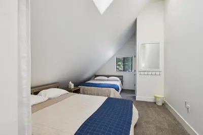 a bedroom with two beds and a window at Spacious Pine Mountain Lake Cabin Rental with Decks in Groveland