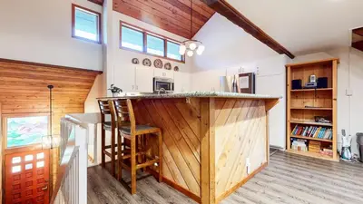 a kitchen with a wooden bar in a house at Snowcreek III #452 condo in Mammoth Lakes