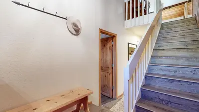 a stairway with a wooden bench in a house at Snowcreek III #452 condo in Mammoth Lakes