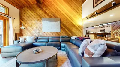 a living room with a blue couch and a table at Snowcreek III #452 condo in Mammoth Lakes