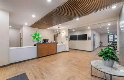 an office lobby with a reception counter and a table at Extended Stay America Premier Suites - Reno - Sparks in Sparks