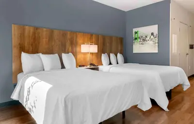 two beds in a hotel room with white sheets at Extended Stay America Premier Suites - Reno - Sparks in Sparks