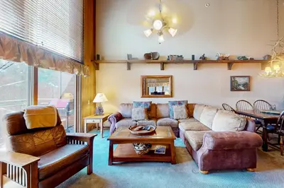 a living room with a couch and a table at Meadow Ridge 34 in Mammoth Lakes
