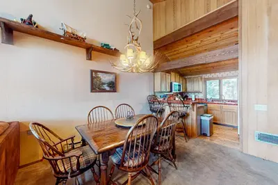 a dining room with a wooden table and chairs at Meadow Ridge 34 in Mammoth Lakes
