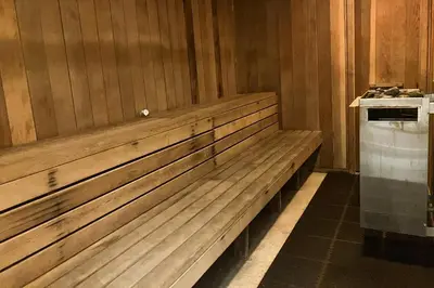 a wooden bench in a room with a stove at Meadow Ridge 34 in Mammoth Lakes