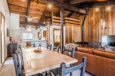 a dining room with a wooden table and a couch at Lakeview Lodge #2 condo in Mammoth Lakes