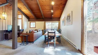 a dining room and living room with a wooden ceiling at Lakeview Lodge #2 condo in Mammoth Lakes