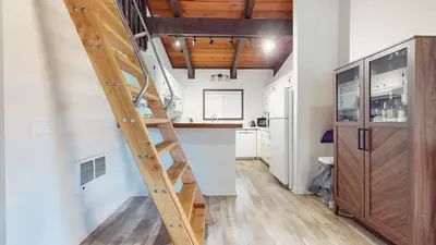 a ladder leading to the kitchen in a tiny house at Lakeview Lodge #1 condo in Mammoth Lakes