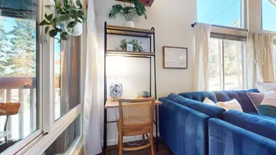 a living room with a blue couch and a table at Courchevel #5 condo in Mammoth Lakes