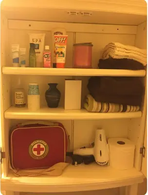 a cupboard with a shelf with various items on it at Stewart Chalet @ Yosemite/Bass Lake in Bass Lake