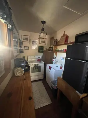 a small kitchen with a stove and a refrigerator at Stewart Chalet @ Yosemite/Bass Lake in Bass Lake
