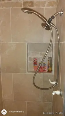 a shower with a shower head in a bathroom at Shirley Creek Retreat: a Mountain Oasis in Wofford Heights