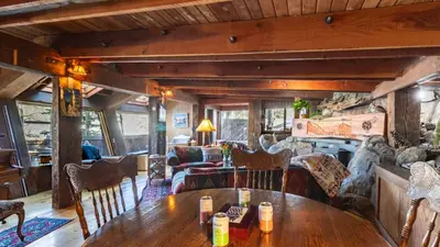 a living room with a wooden table and chairs at Mt. Jola by AvantStay A 5-minute walk away to Palisades and lifts. in Olympic Valley