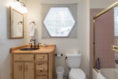 a bathroom with a sink and a toilet and a window at Tahoe Vista Home w/ Spa close to Northstar & Lake in Tahoe Vista