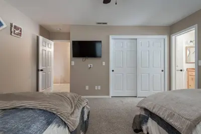 a bedroom with two beds and a flat screen tv at Tahoe Vista Home w/ Spa close to Northstar & Lake in Tahoe Vista