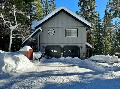 a house is covered in snow with trees at Tahoe Vista Home w/ Spa close to Northstar & Lake in Tahoe Vista
