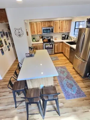 a kitchen with a white table and chairs and a refrigerator at Walking Distance To The Lake And Beach! in Kings Beach