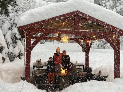 a group of people sitting in a gazebo in the snow at Walking Distance To The Lake And Beach! in Kings Beach