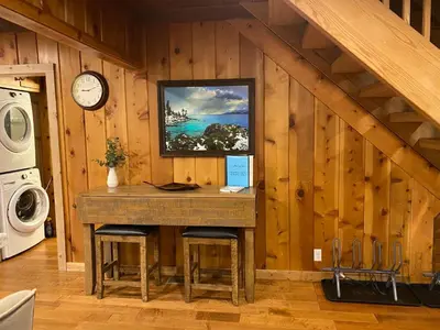 a kitchen with a table and a clock on a wall at FamilyfunCabin in Tahoma