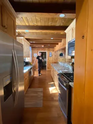 a man is standing in a kitchen at FamilyfunCabin in Tahoma
